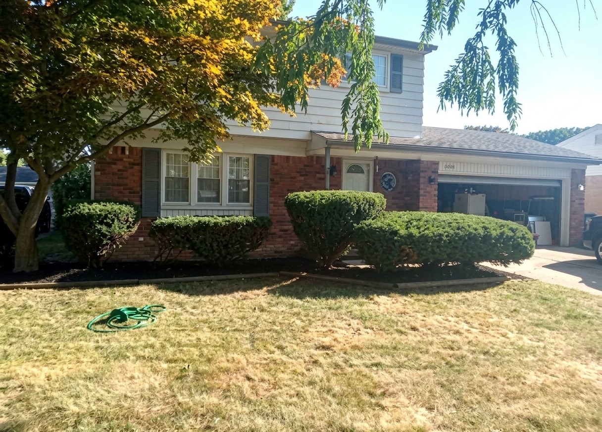 Residential front yard with freshly trimmed shrubs and tidy bed lines